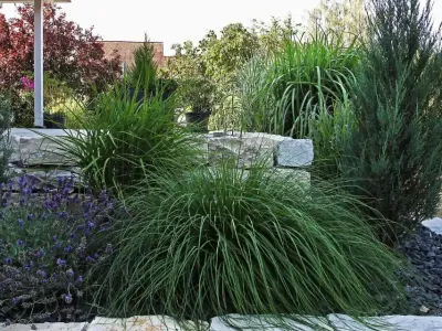Stabile Hangabsicherung aus Naturstein mit Pflanzebenen für eine moderne Gartengestaltung.